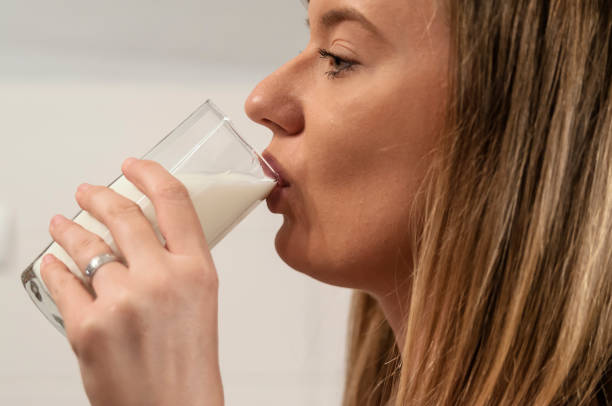 istock Happy young housewife drinking milk. 883109690