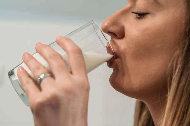 istock Woman drinking milk. Weight loss concept. 883109750