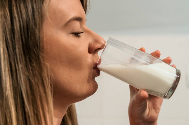 istock Happy young housewife drinking milk. 883109856