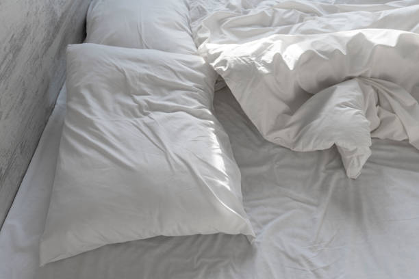 istock Used linens, bed sheet and pillows messed up 883111040