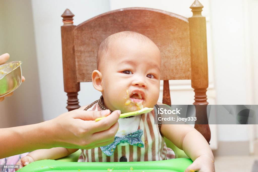 Baby feeding Healthy baby eating a delicious food Baby - Human Age Stock Photo