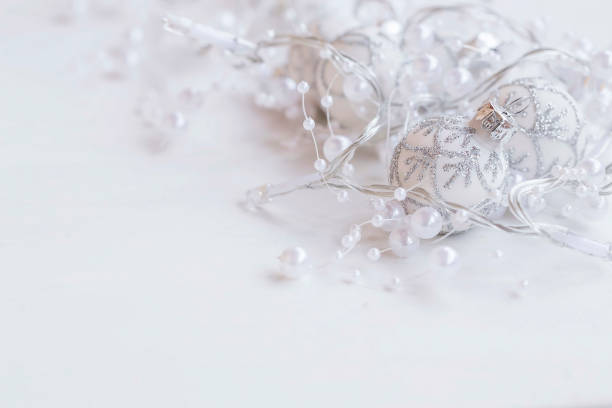 istock Silver festive Christmas decorations with balls and pearls garland with copy space 883114620