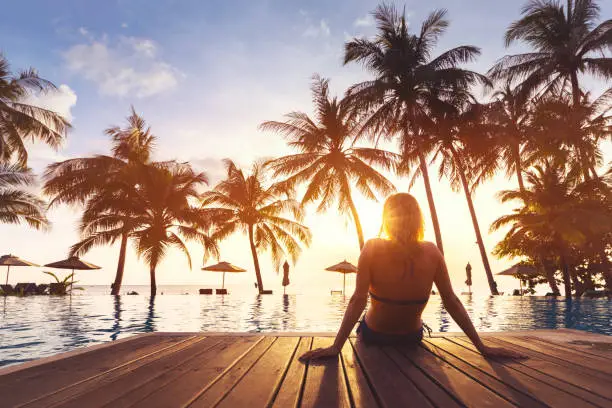 Photo of Woman enjoying vacation holidays luxurious beachfront hotel resort swimming pool
