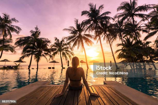 Woman Relaxing By The Pool In Luxurious Beachfront Hotel Resort Stock Photo - Download Image Now