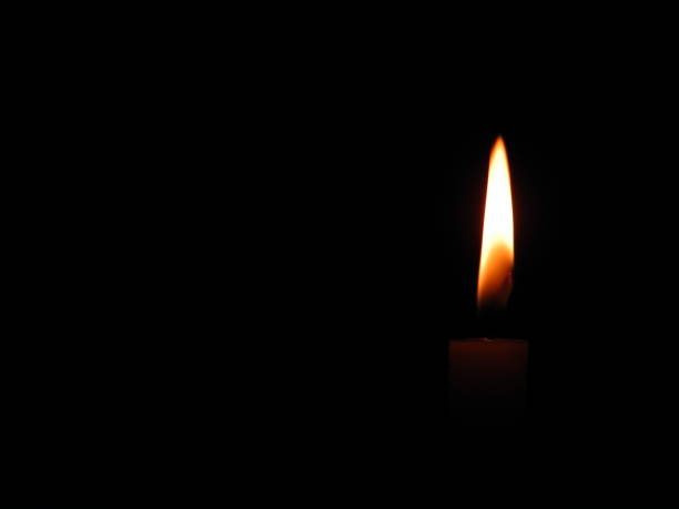 istock lit candle, christmas lights 883121474