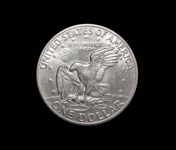 istock One US dollar coin on isolated black background 883136394