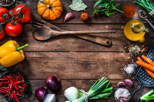 istock Frame of assorted fresh vegetables on rustic wooden table 883136398