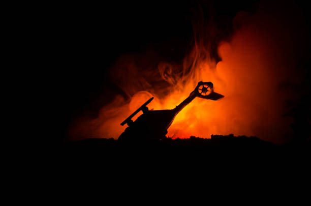 istock Air Crash. Burning falling helicopter. Destroyed helicopter. Decorated with toy at dark fire background. War or terrorism 883139142
