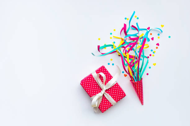 istock Colorful confetti,streamers and gift box.Flat lay 883139232