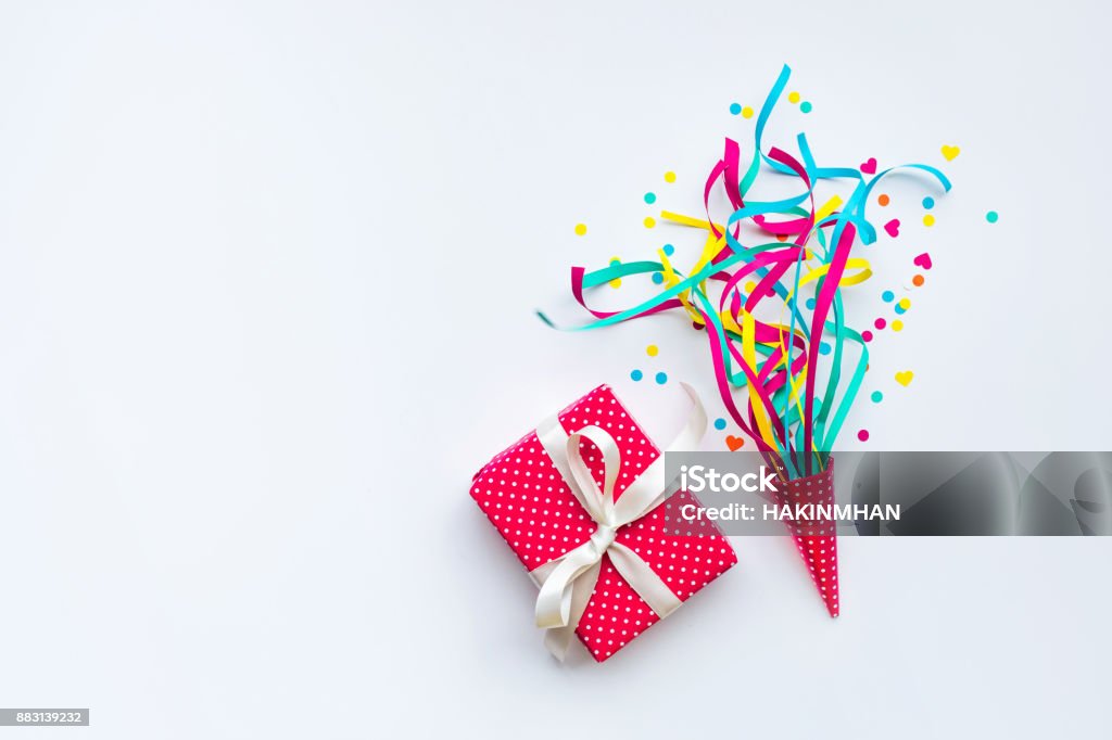 Colorful confetti,streamers and gift box.Flat lay Celebration,party backgrounds concepts ideas with colorful confetti,streamers and gift box.Flat lay design Business Stock Photo