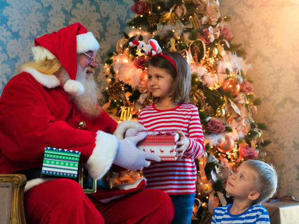 istock Santa Claus gives presents 883140132