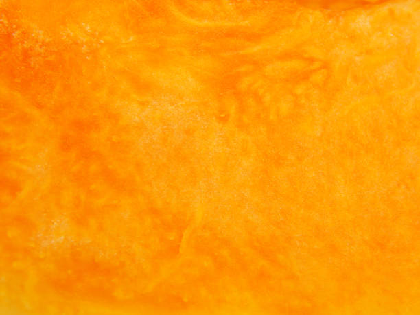 istock Slice of pumpkin macro textured background 883143876
