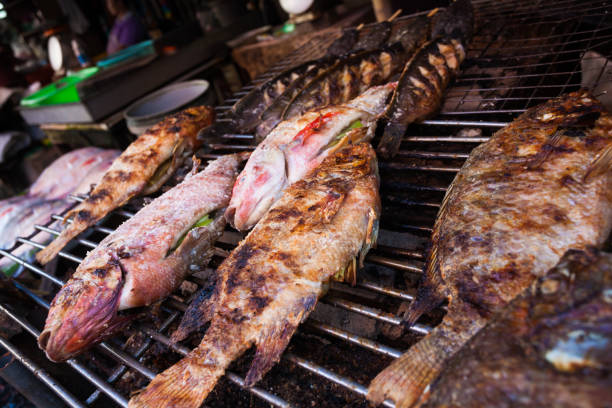 istock Fish on grill in Bangkok market 883147550