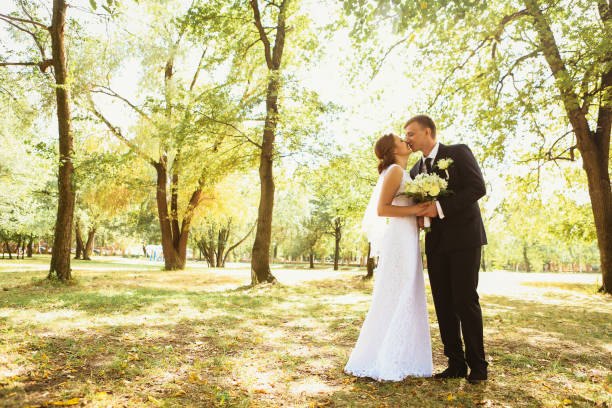 istock couple bride and groom on a park background 883153742