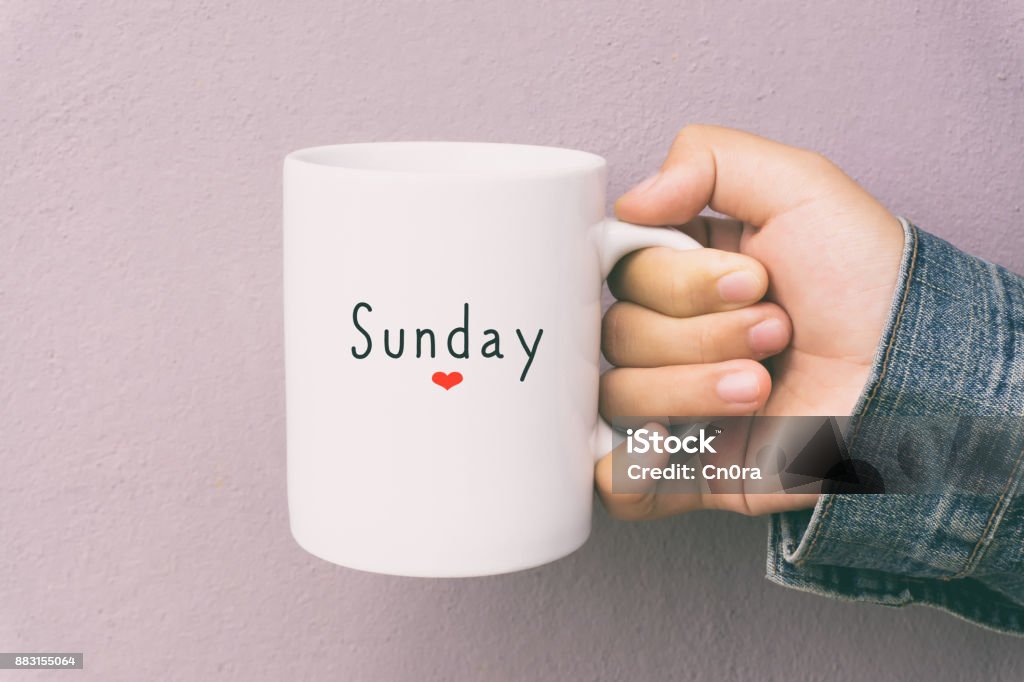 Sunday and Coffee - Woman Holding a Cup of Coffee Woman Hand Holding a Cup of Coffee With Text Sunday. Sunday Stock Photo