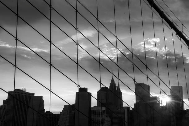 istock New York Manhattan Skyscraper  on the Brooklyn bridge sunset 883157726