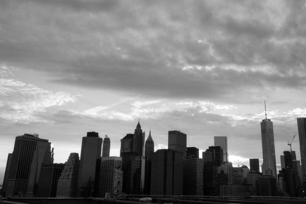 istock New York Manhattan Skyscraper  on the Brooklyn bridge sunset 883157836