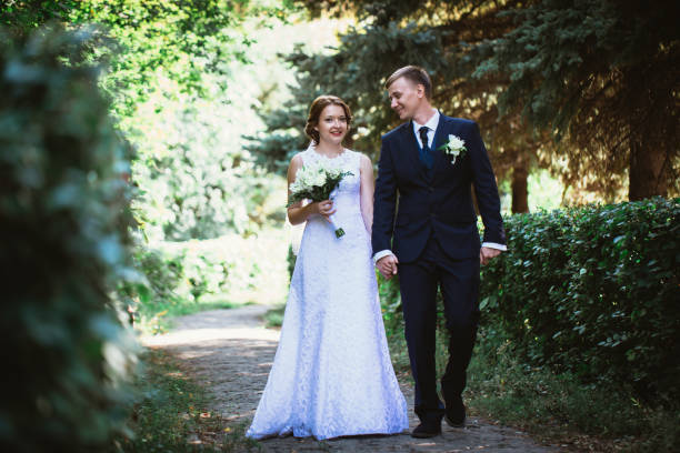 istock couple bride and groom on a park background 883160034
