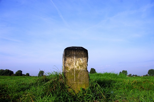 Old historical stone as a marking in the Field near the Dutch Belgian border.