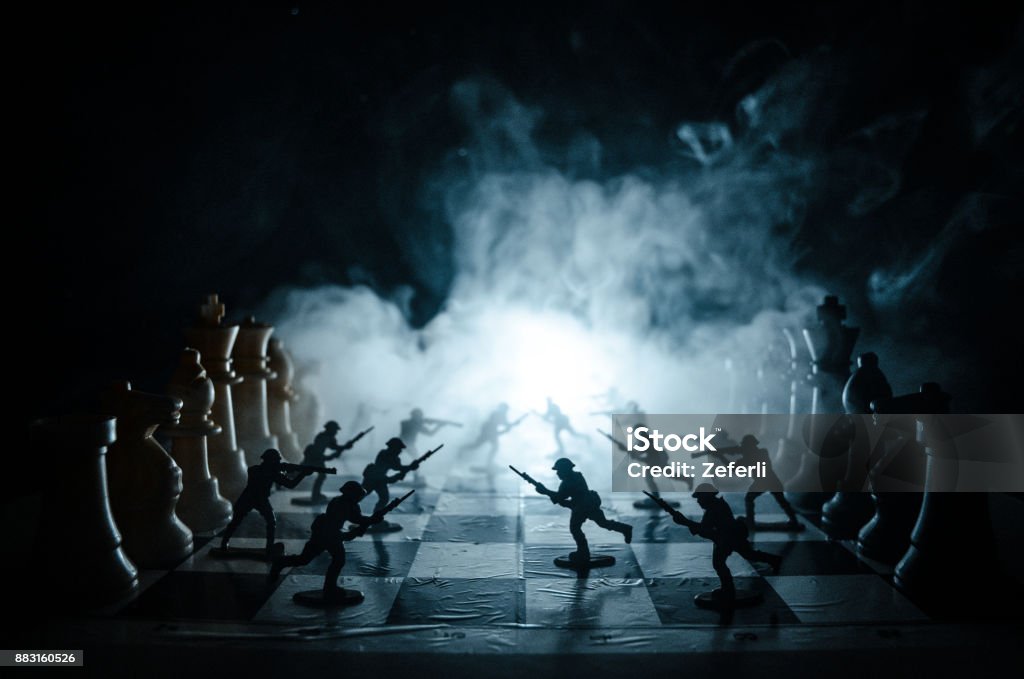 War concept. Silhouettes of soldiers on chessboard. War Concept. Military silhouettes fighting scene on war fog sky background, Chess board game concept of business ideas and competition War concept. Silhouettes of soldiers on chessboard. War Concept. Military silhouettes fighting scene on war fog sky background, Chess board game concept of business ideas and competition and strategy War Stock Photo