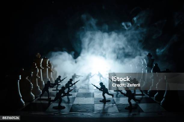 War Concept Silhouettes Of Soldiers On Chessboard War Concept Military Silhouettes Fighting Scene On War Fog Sky Background Chess Board Game Concept Of Business Ideas And Competition Stock Photo - Download Image Now