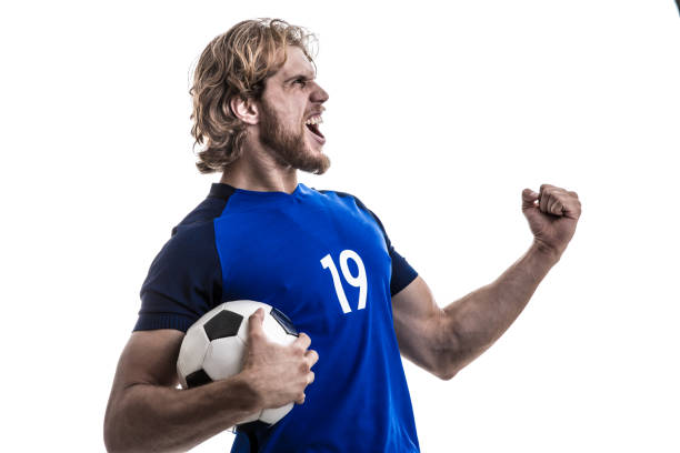 istock Male athlete / fan in blue uniform celebrating on white background 883160564