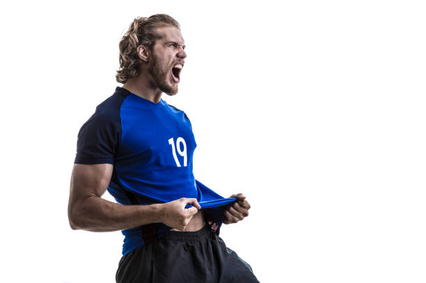 istock Male athlete / fan in blue uniform celebrating on white background 883160576