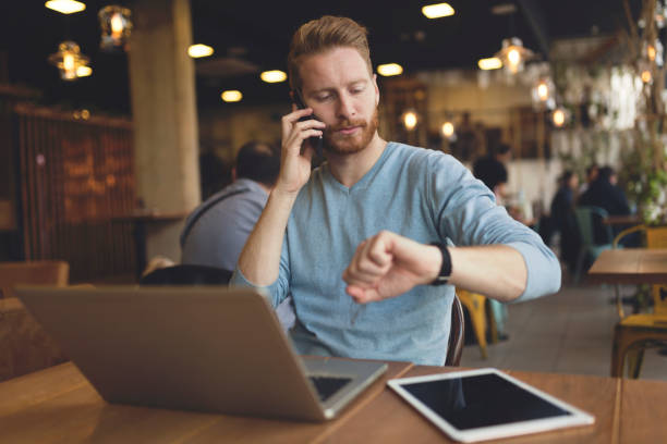 istock Young busy man having phone call in cafe 883161084