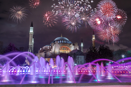 View of the Hagia Sophia at night with fireworks on the black sky in Istanbul, Turkey.