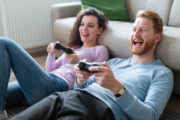 istock Young couple having fun playing video games 883167518