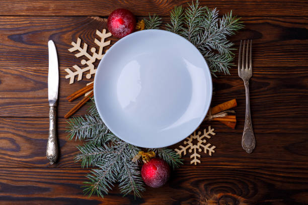 istock Served table decorated with Christmas tree branches, balls, snowflakes and cinnamon sticks. 883170572