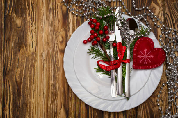 istock Christmas table place setting with pine branches,ribbon and bow. 883171006