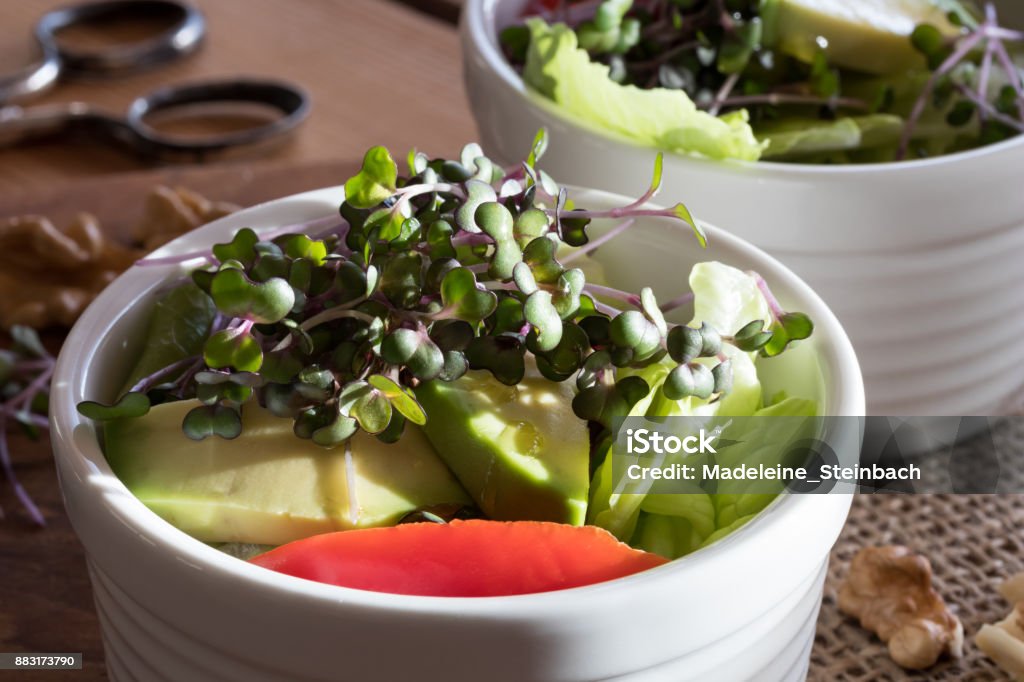 Fresh kale and broccoli microgreens in a vegetable salad Fresh kale and broccoli microgreens on top of a vegetable salad Avocado Stock Photo