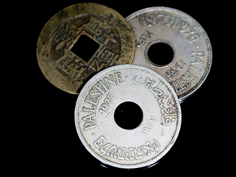 3 old vintage coins together on black background