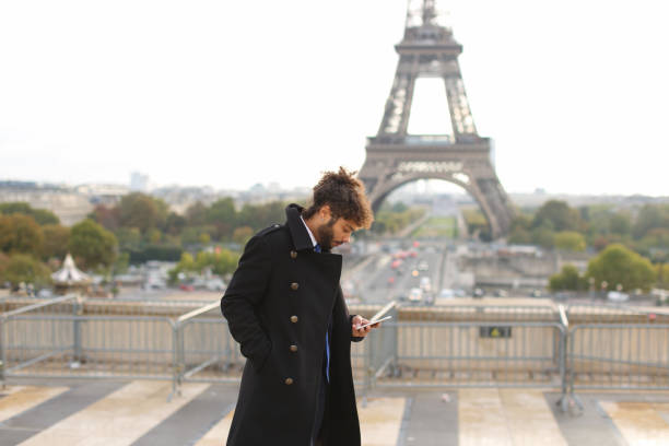 istock Arabian groom talking on smartphone near Eifel Tower in slow mot 883176820