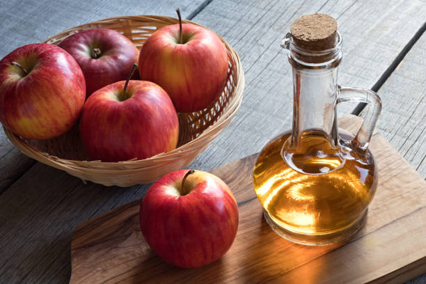 istock A bottle of apple cider vinegar with apples 883181800