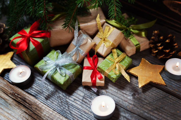 istock Modern gifts on a wooden rustic table with copy space. Christmas background. View from above. 883184422