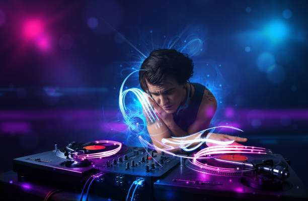 istock Disc jockey playing music with electro light effects and lights 883184982