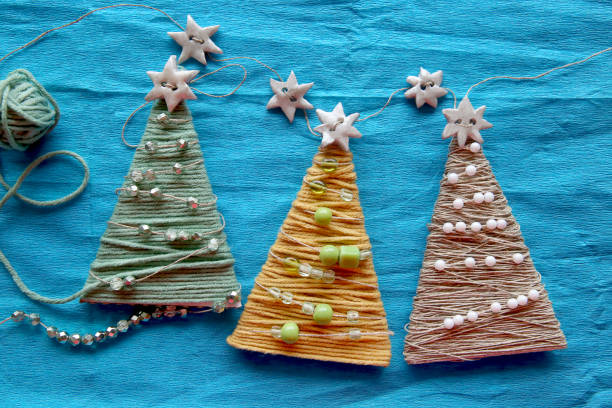 istock Handmade christmas trees on blue creped paper. 883187738