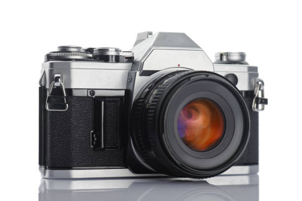 istock Old vintage film camera with lens on white background 883190250