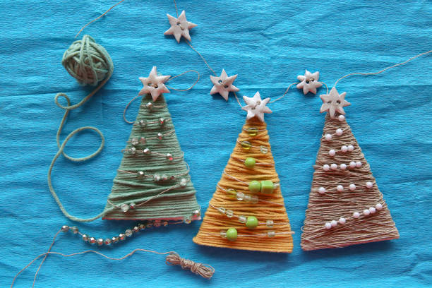 istock Handmade christmas trees on blue creped paper. 883190324