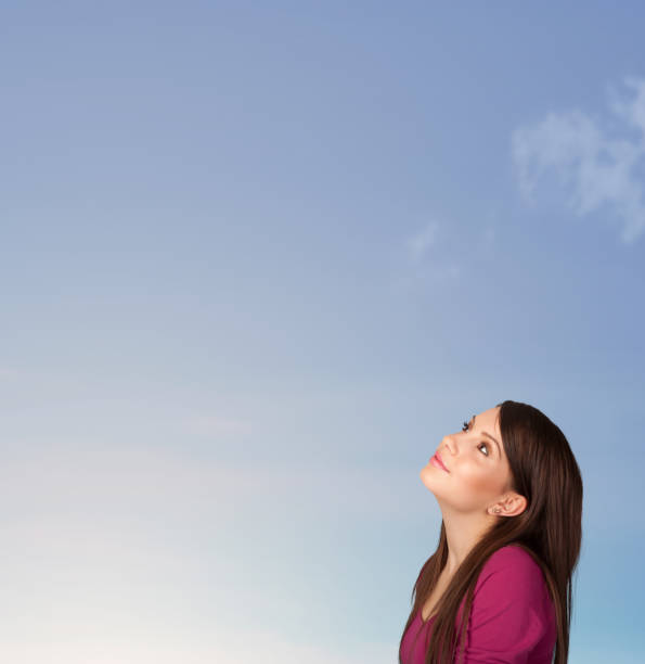 istock Girl looking at the blue sky copyspace 883190678