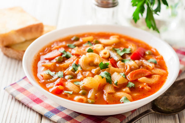 istock Italian minestrone soup on white wooden background. 883197042
