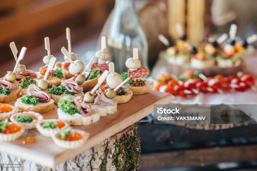 Misted decanter of vodka and traditional Ukrainian snack Beautifully decorated catering banquet table with different food snacks and appetizers on corporate christmas birthday party event or wedding celebration Buffet Stock Photo