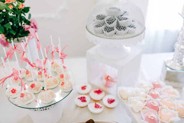 istock Wedding reception dessert table with delicious decorated white cupcakes with frosting 883203752