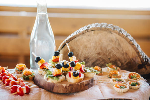 Three types of bite-sized savory tartlets with assorted fillings served on a wooden board, perfect for party appetizers or catering.