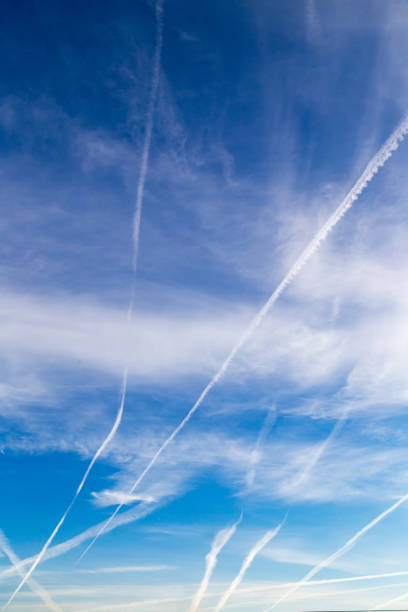 istock traces of an airplane on a blue sky 883204974