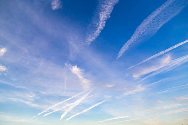 istock traces of an airplane on a blue sky 883205522