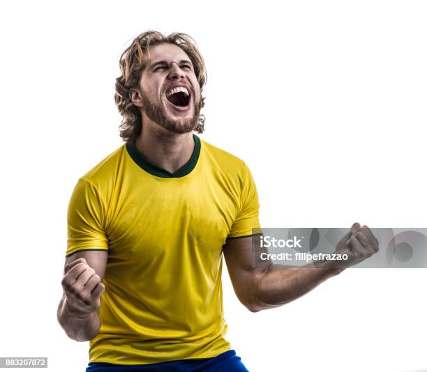 Male Athlete Fan In Yellow Uniform Celebrating On White Background Stock Photo - Download Image Now