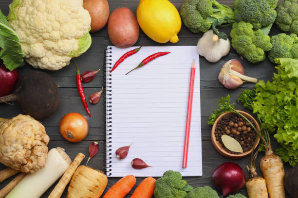 istock Fresh vegetables on dark wooden background. Mockup for menu or recipe. Top view with copy space 883207918